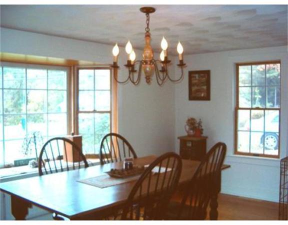 91 Ryan Road Northampton, MA 01062 - Photo 10 of 24 a view of a dining room with furniture a chandelier and large windows