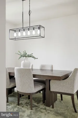 a dining room with furniture a window and chandelier