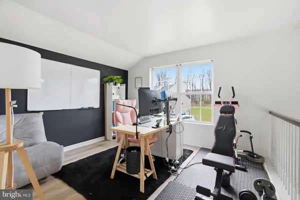 a living room with furniture a flat screen tv and a window