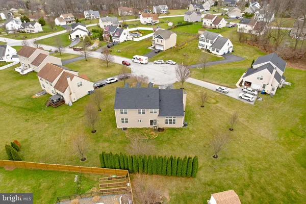front view of a brick house with a yard