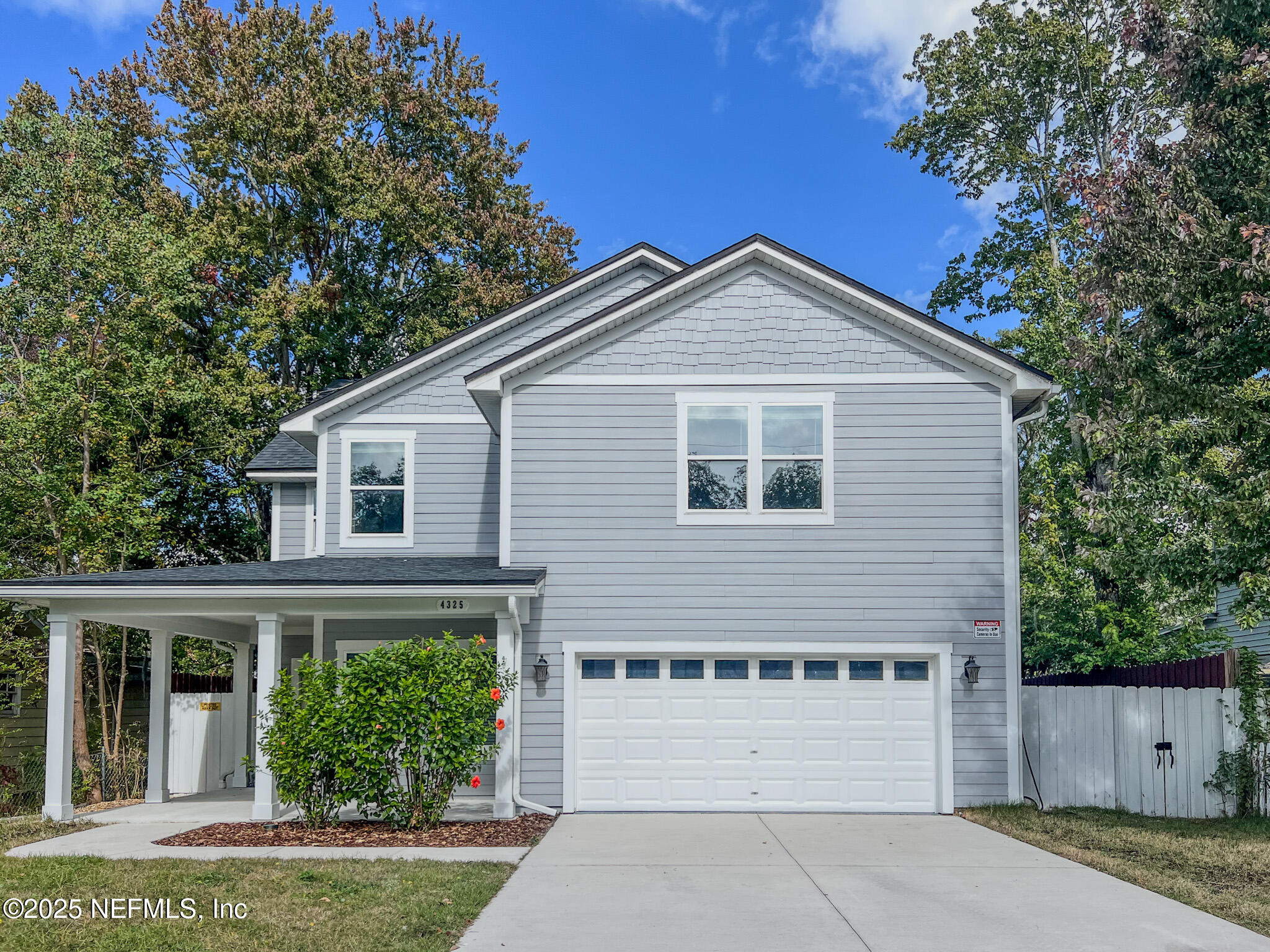 a view of a house with a yard and plants