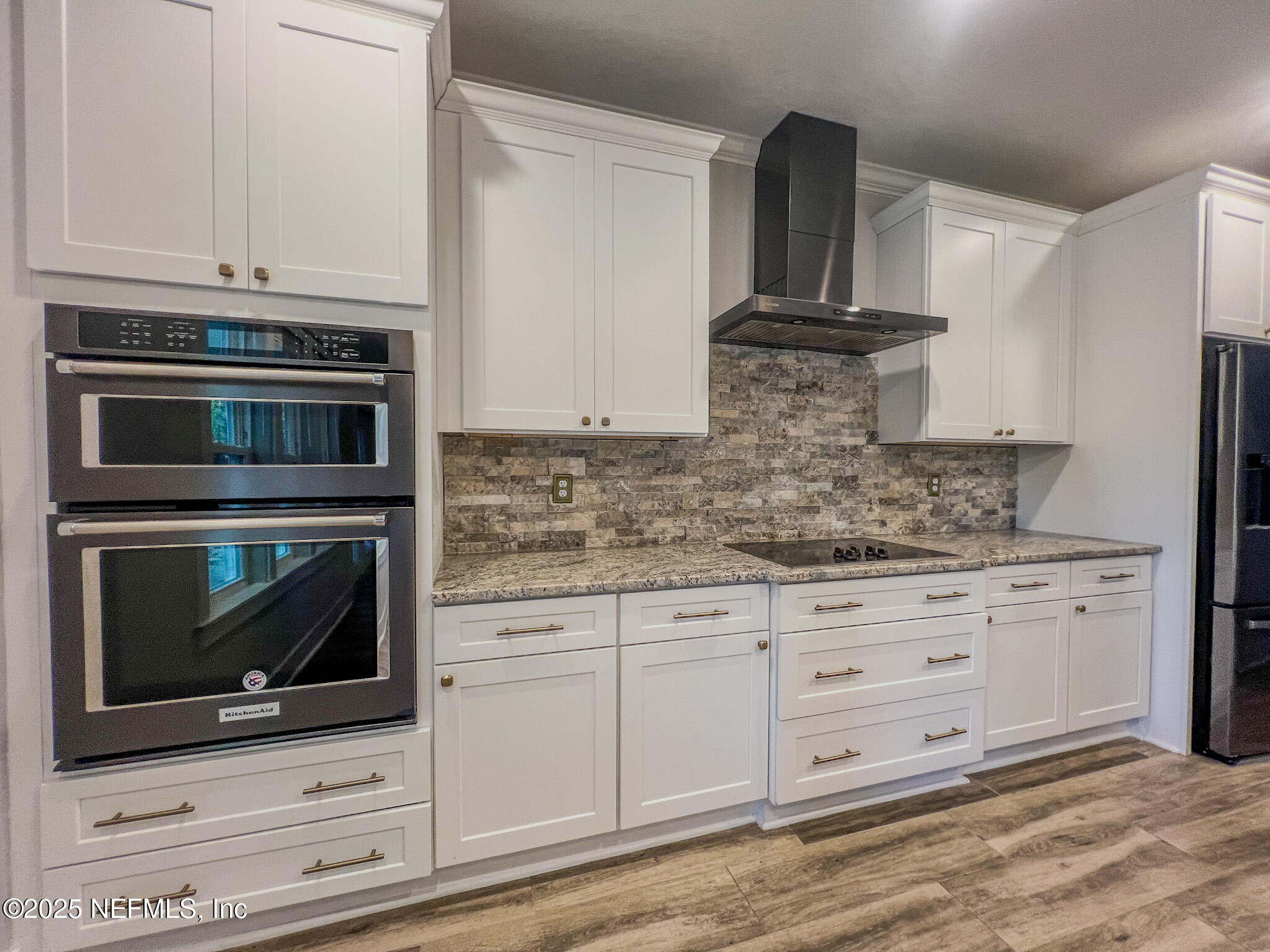 4325 Appleton Avenue Jacksonville, FL 32210 - Photo 10 of 40 a kitchen with granite countertop white cabinets and stainless steel appliances