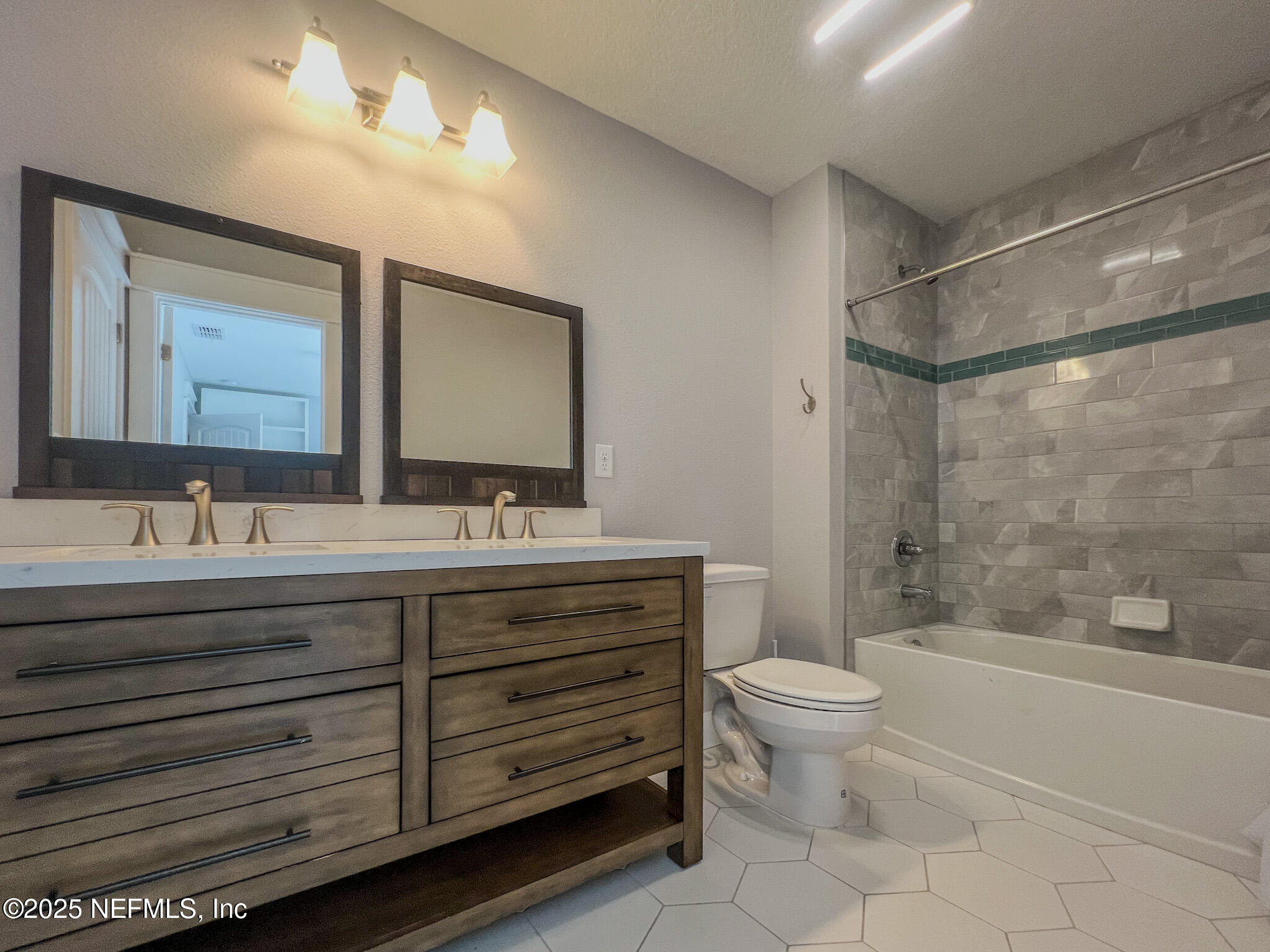 4325 Appleton Avenue Jacksonville, FL 32210 - Photo 32 of 40 a bathroom with a double vanity sink toilet mirror and shower