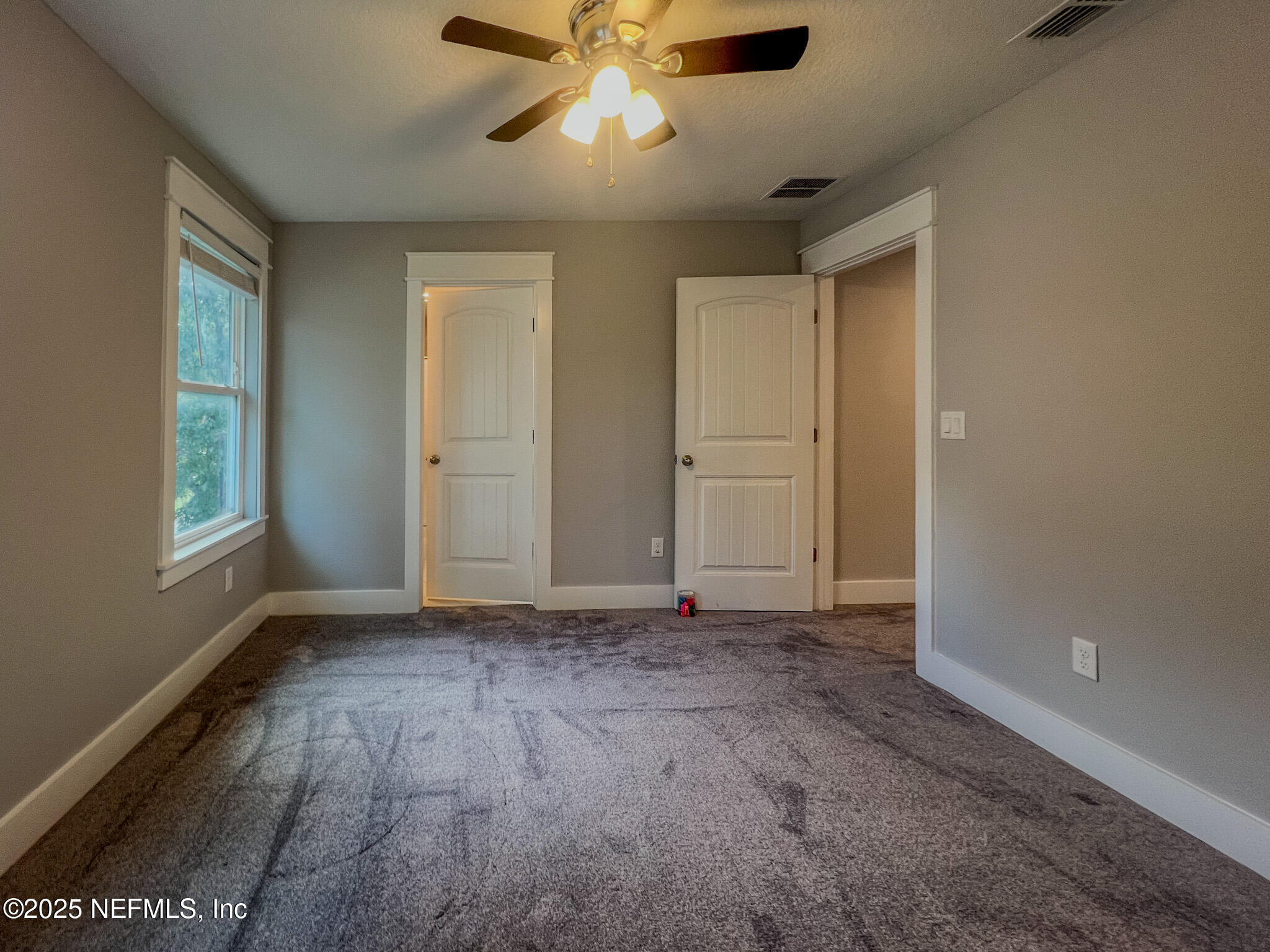 4325 Appleton Avenue Jacksonville, FL 32210 - Photo 34 of 40 a view of an empty room with window and chandelier fan
