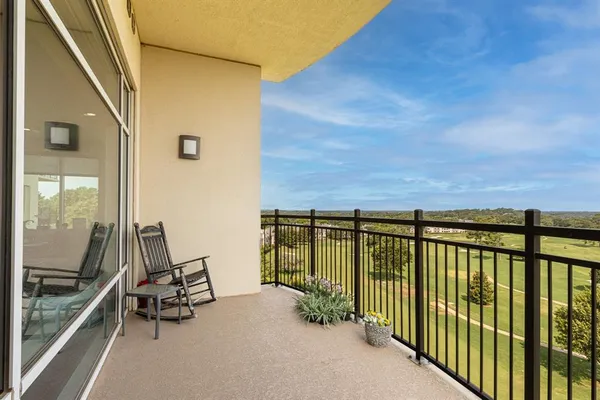 a view of a patio with a dining table and chairs