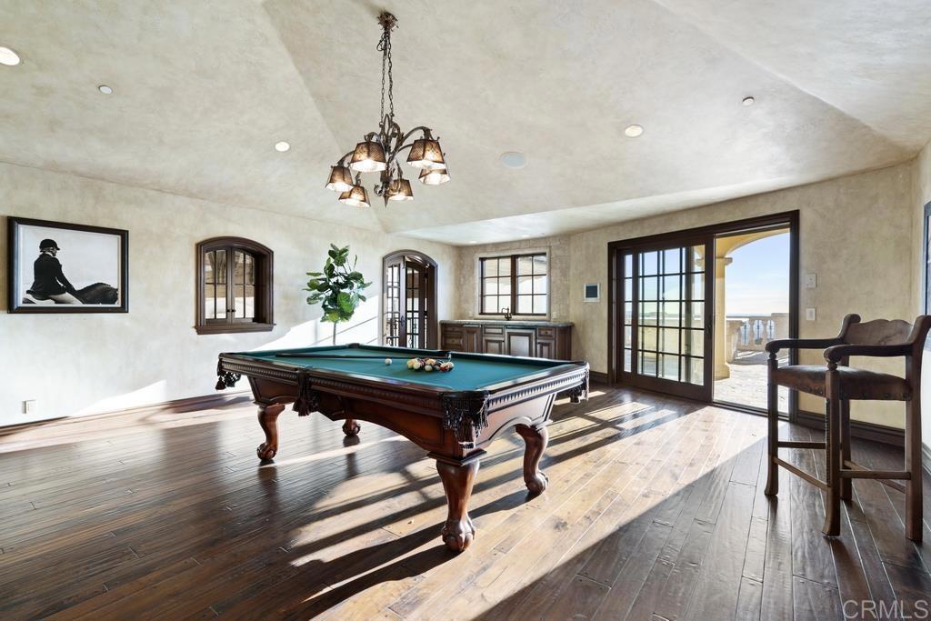 18441 Via Ambiente Rancho Santa Fe, CA 92067 - Photo 19 of 35 a living room with furniture a dining table and a wooden floor