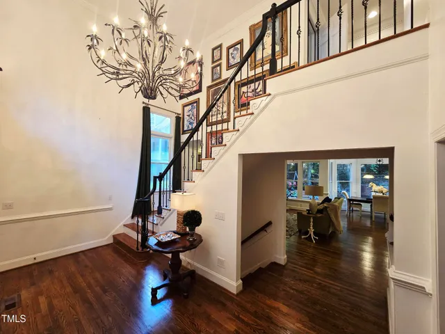 a kitchen with stainless steel appliances granite countertop a stove a sink dishwasher and a oven with white cabinets