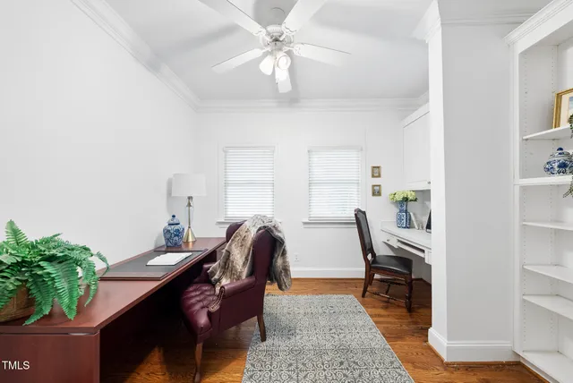 a bedroom with a bed and a lamp on the dresser