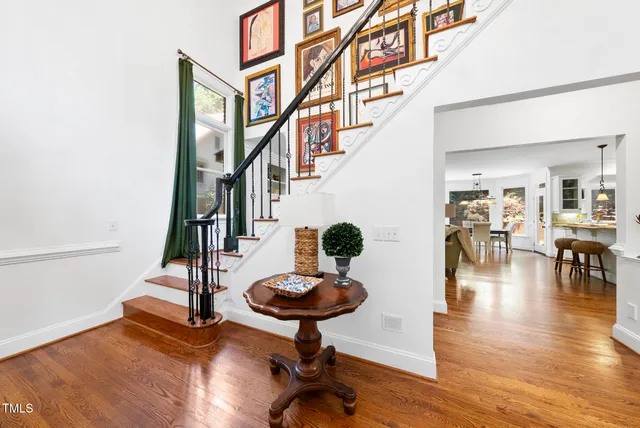 a living room with stainless steel appliances kitchen island granite countertop furniture and wooden floor
