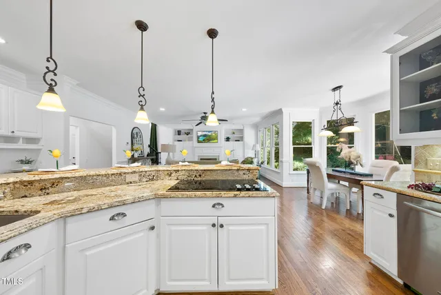 a large white kitchen with a large window