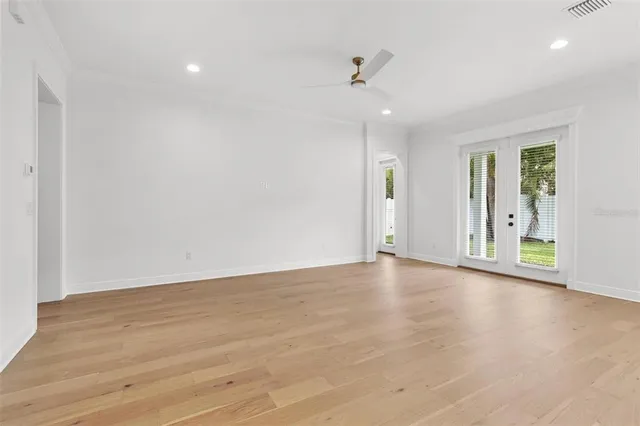 a large white kitchen with cabinets a sink a center island and stainless steel appliances
