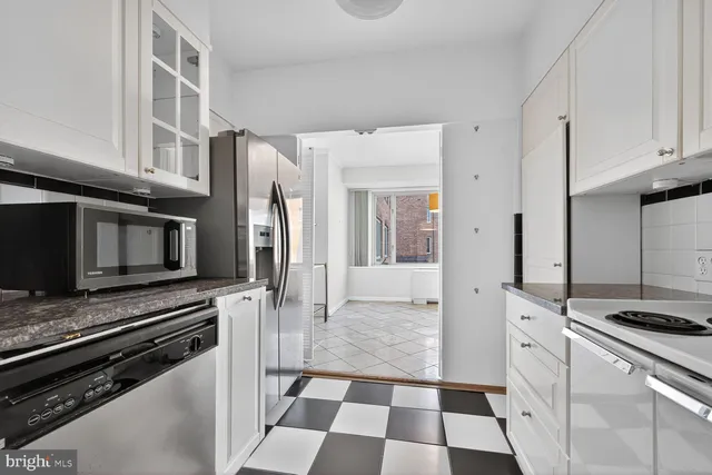 a kitchen with stainless steel appliances a stove a microwave and a refrigerator