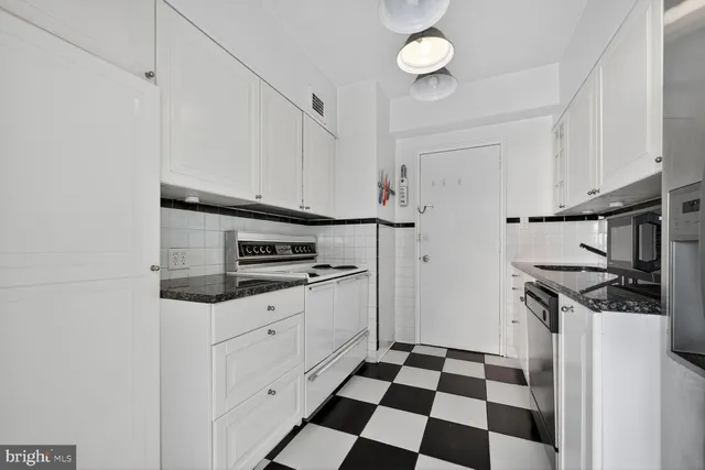 a kitchen with stainless steel appliances a stove a sink and a refrigerator