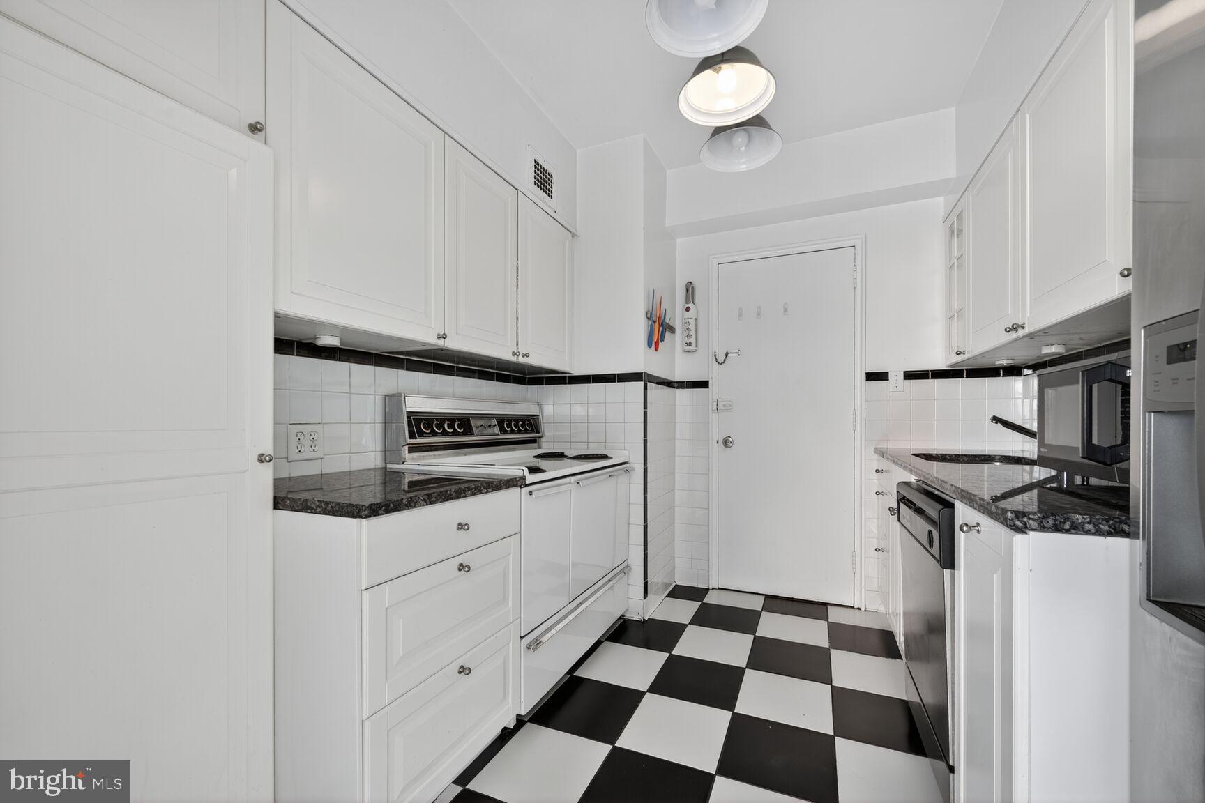 4301 Massachusetts Avenue Northwest, Unit 6014 Washington, DC 20016 - Photo 12 of 22 a kitchen with stainless steel appliances a stove a sink and a refrigerator