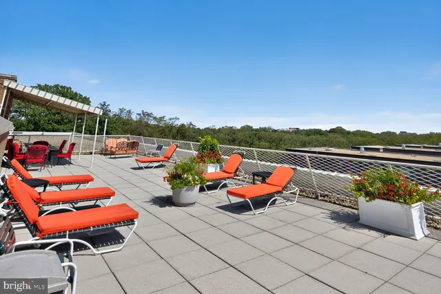 an outdoor living space with furniture and city view