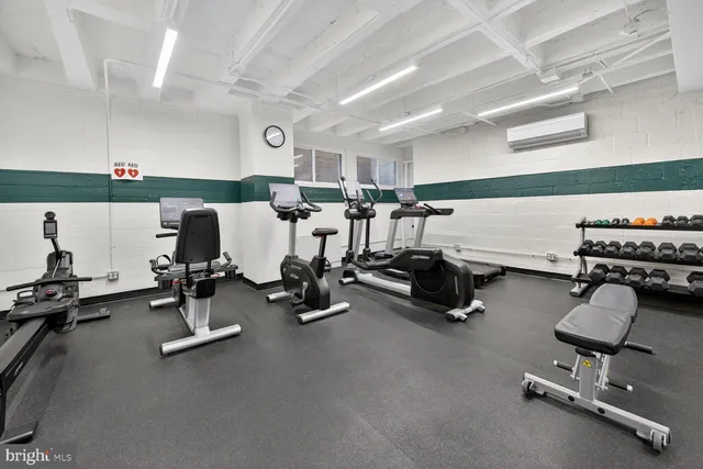 a room with gym equipment and a table