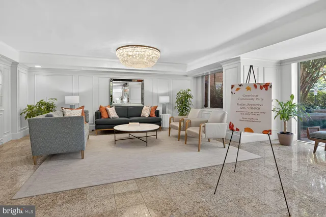 a living room with furniture a potted plant and a table