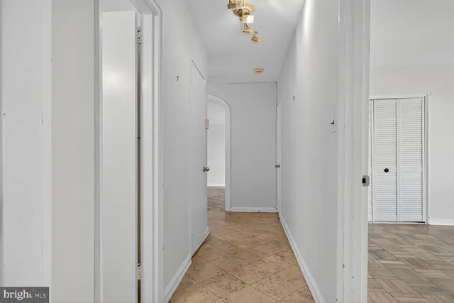 a view of a hallway with wooden floor
