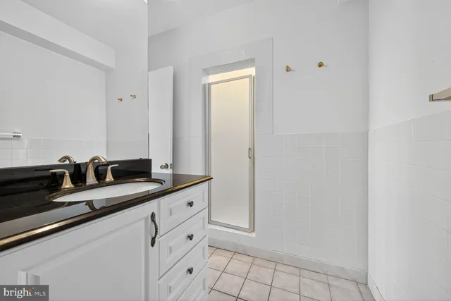 a bath room with a sink and a mirror
