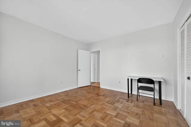 a bedroom with a bed and a chair