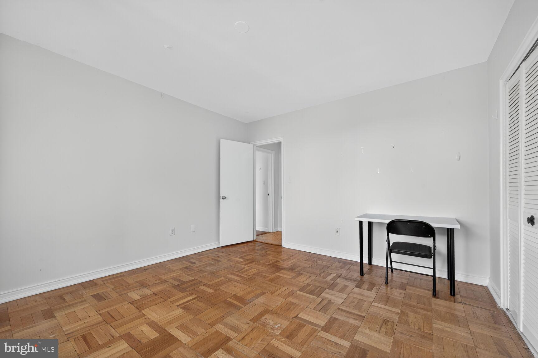 4301 Massachusetts Avenue Northwest, Unit 6014 Washington, DC 20016 - Photo 9 of 22 a bedroom with a bed and a chair