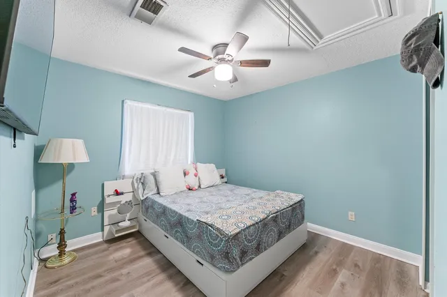 a bedroom with a bed and a chandelier