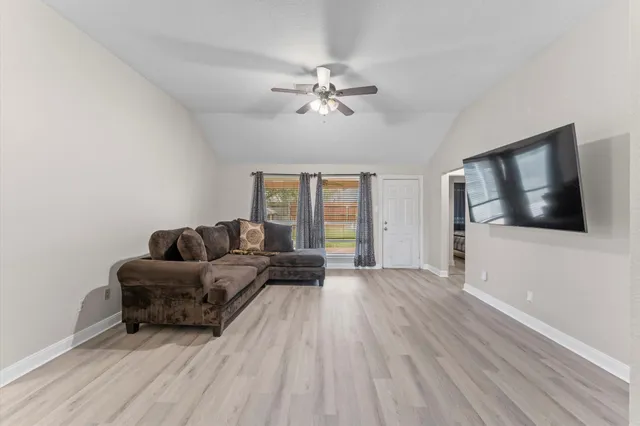 a living room with furniture and a flat screen tv