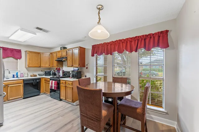 a view of a dining room with furniture window and outside view