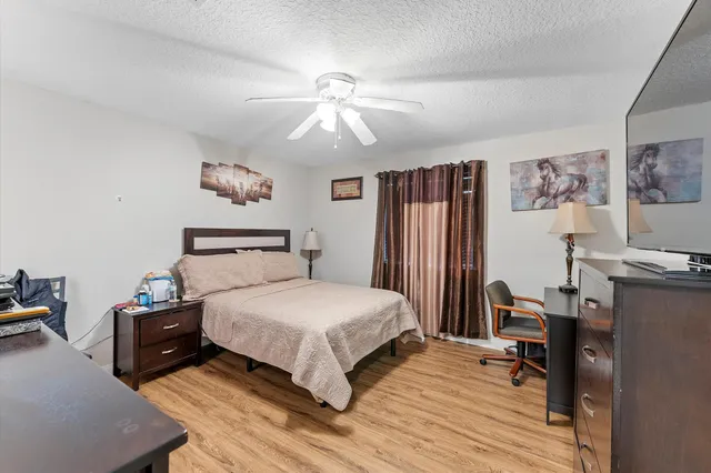 a bedroom with a bed and wooden floor