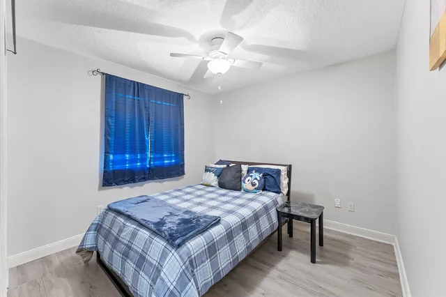 a bedroom with a bed and a chandelier