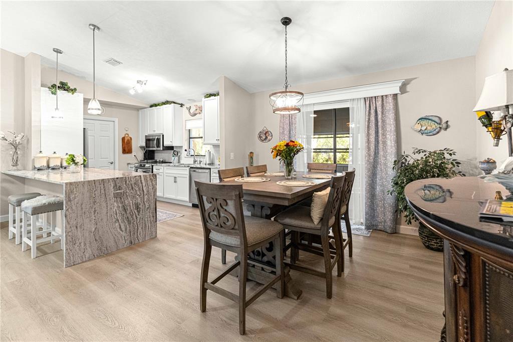 1155 East Bismark Street Hernando, FL 34442 - Photo 15 of 52 a dining room with furniture a chandelier and wooden floor