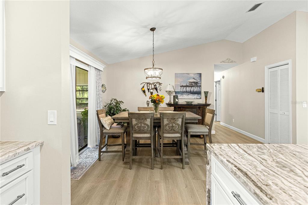 1155 East Bismark Street Hernando, FL 34442 - Photo 16 of 52 a dining room with a table and chairs