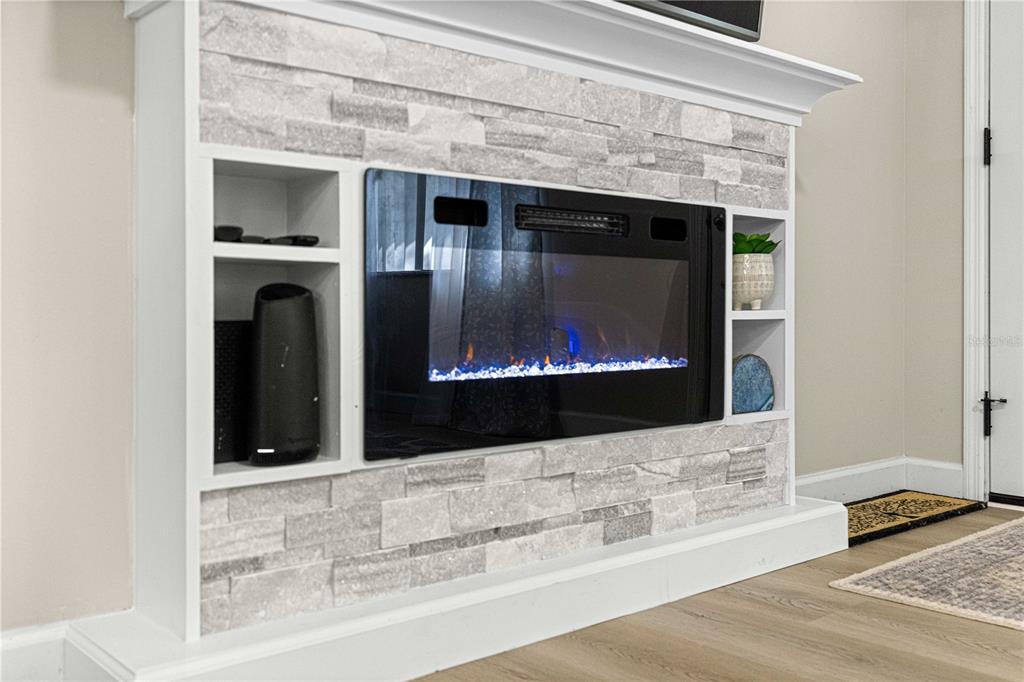 1155 East Bismark Street Hernando, FL 34442 - Photo 18 of 52 a living room with a fireplace and a flat screen tv