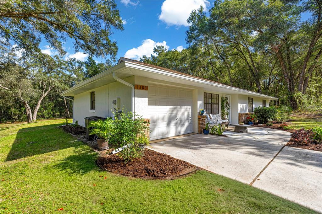 1155 East Bismark Street Hernando, FL 34442 - Photo 42 of 52 a front view of house with yard and outdoor seating