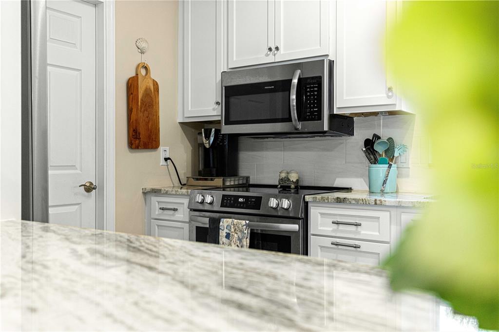 1155 East Bismark Street Hernando, FL 34442 - Photo 9 of 52 a kitchen with stainless steel appliances a stove and a microwave