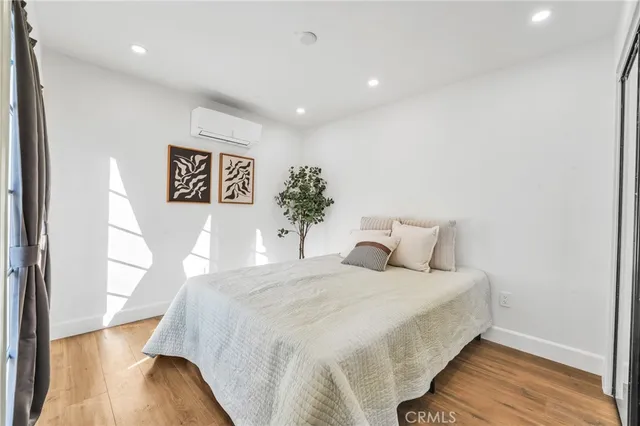 a bedroom with a bed and a painting on the wall