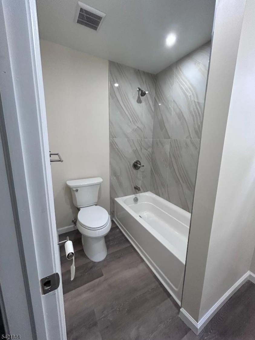 22 Cross Street Union, NJ 07088 - Photo 11 of 14 a bathroom with a granite countertop toilet a sink and a bathtub