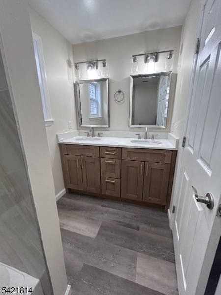 22 Cross Street Union, NJ 07088 - Photo 12 of 14 a bathroom with a double vanity sink and mirror