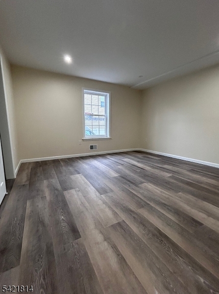 22 Cross Street Union, NJ 07088 - Photo 7 of 14 an empty room with wooden floor and windows