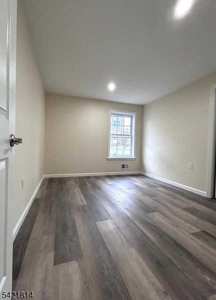 22 Cross Street Union, NJ 07088 - Photo 8 of 14 an empty room with wooden floor and windows