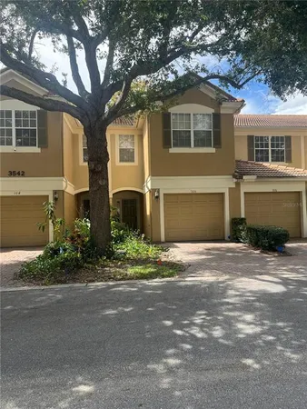 a front view of a house with a yard and a garage
