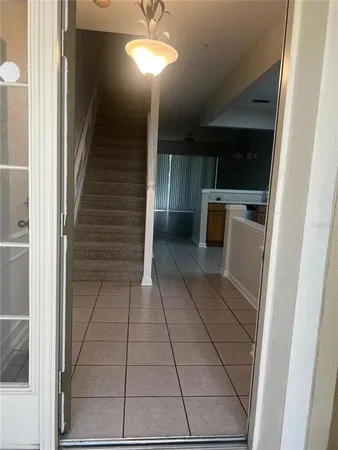 a view of a hallway to rooms and stairs