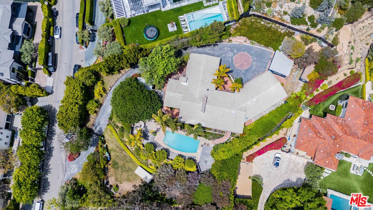 an aerial view of a house with a yard and garden