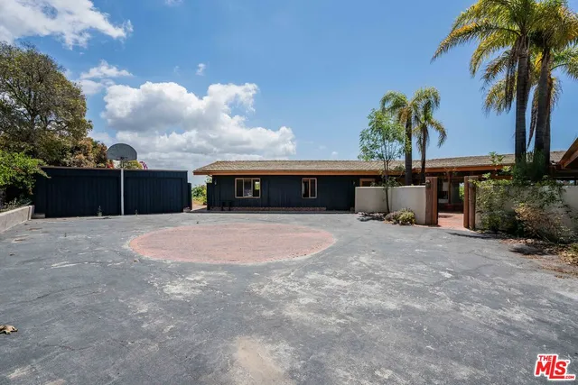 a front view of a house with a yard and a garage