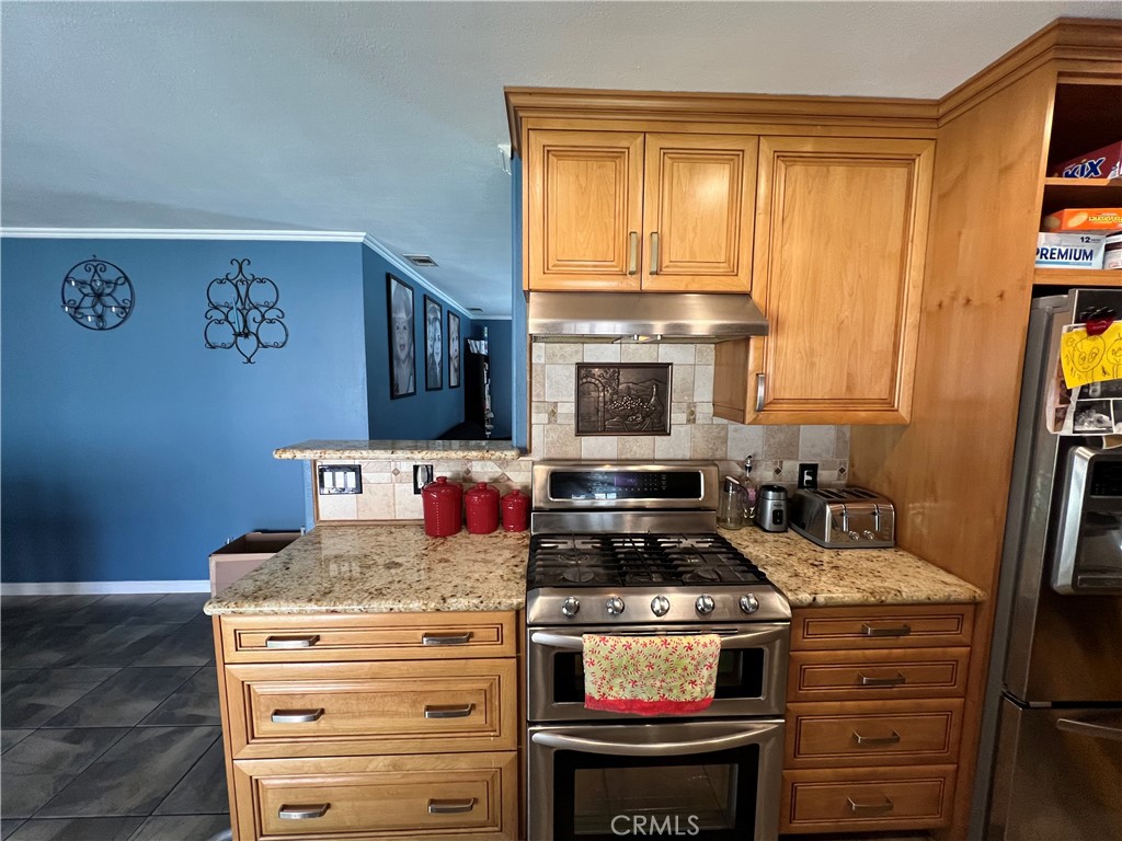 646 Boulder Street Fillmore, CA 93015 - Photo 3 of 10 a kitchen with stainless steel appliances granite countertop a stove and a refrigerator