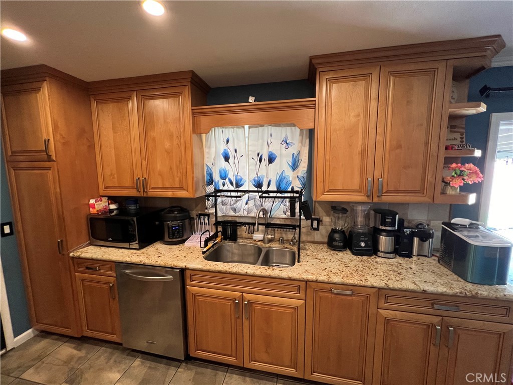 646 Boulder Street Fillmore, CA 93015 - Photo 4 of 10 a kitchen with stainless steel appliances granite countertop a sink a stove and a wooden cabinets