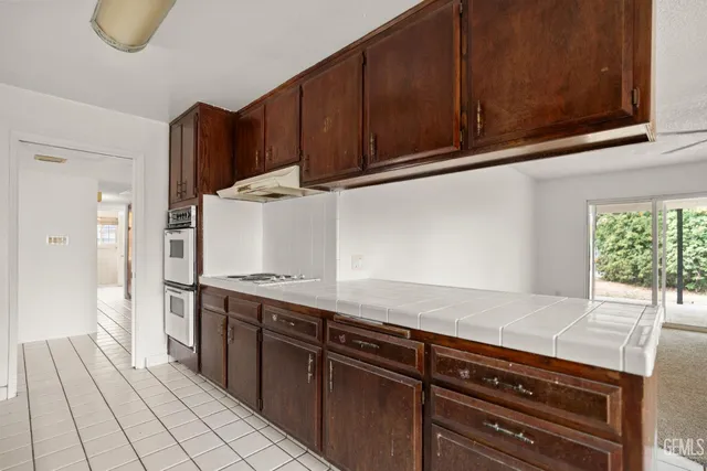 a kitchen with stainless steel appliances granite countertop a stove and cabinets