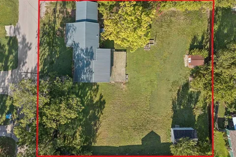 a aerial view of a house with a yard