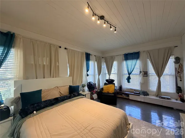 a bed room with a bed and a window