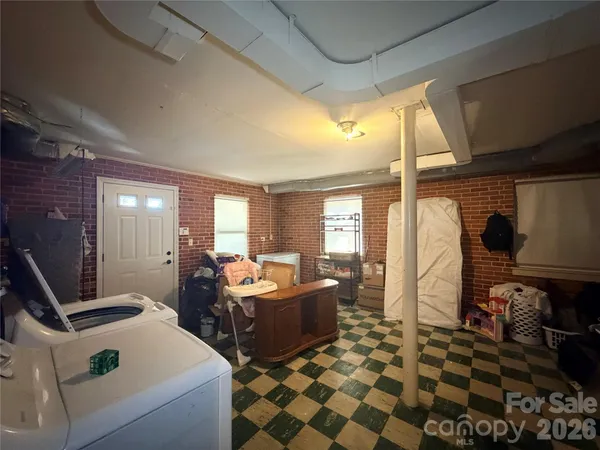 a room with furniture a rug and a window